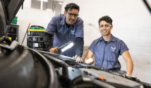 auto-mechanics-working-on-car