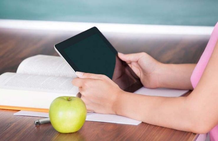 10 Tips to Relieve Stress - UEI College woman holding tablet
