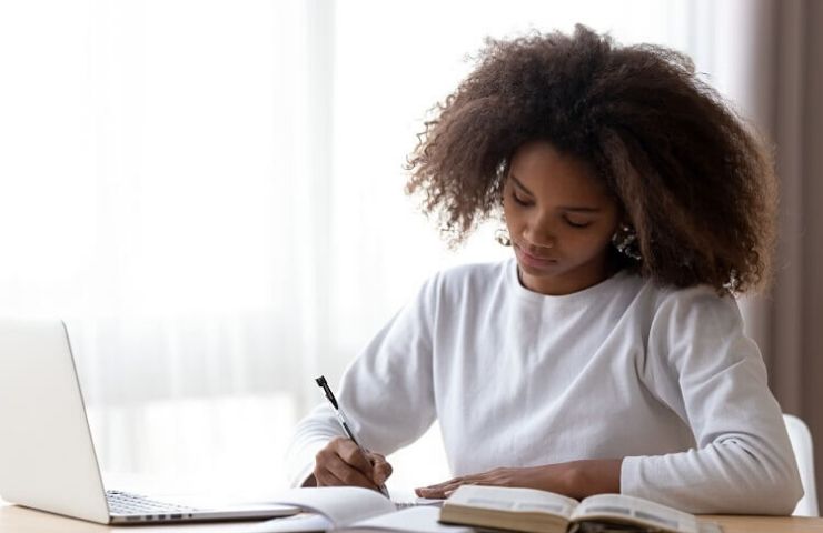 How to Set Yourself Up for Success While You’re Still in School - UEI College woman working on laptop