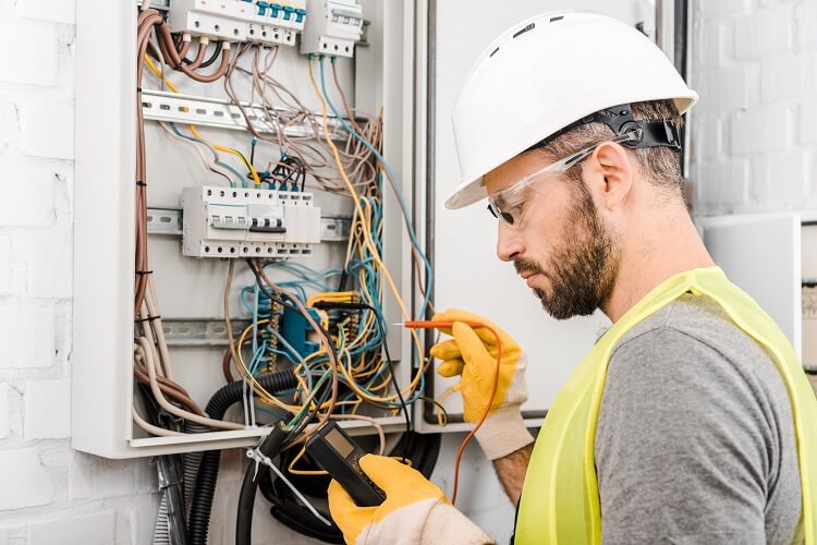 Electrician working on electricity panel