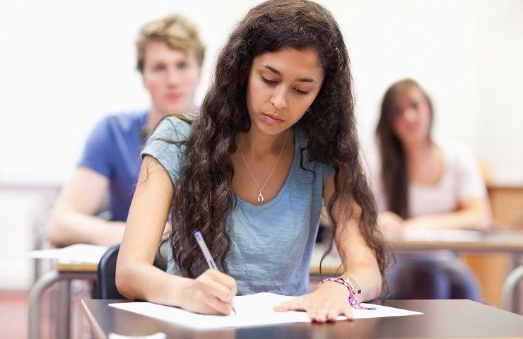 students writing on paper