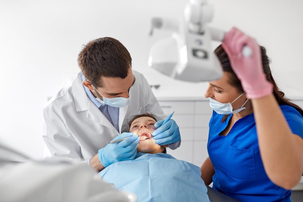 dental-assistant-helping-dentist