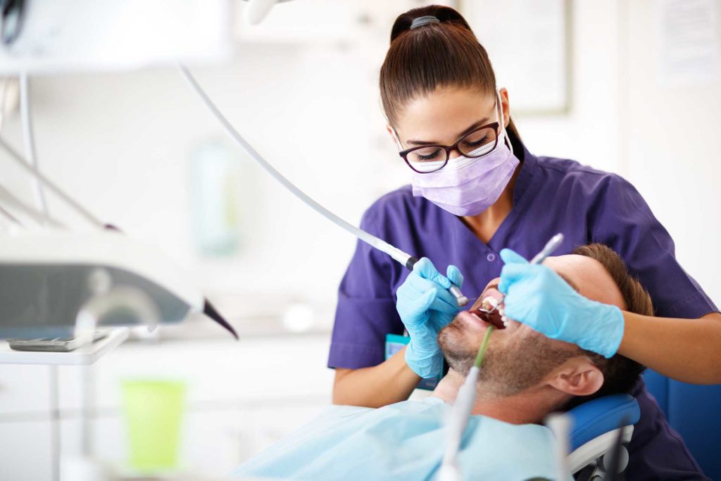 dental-assistant-working-on-patient